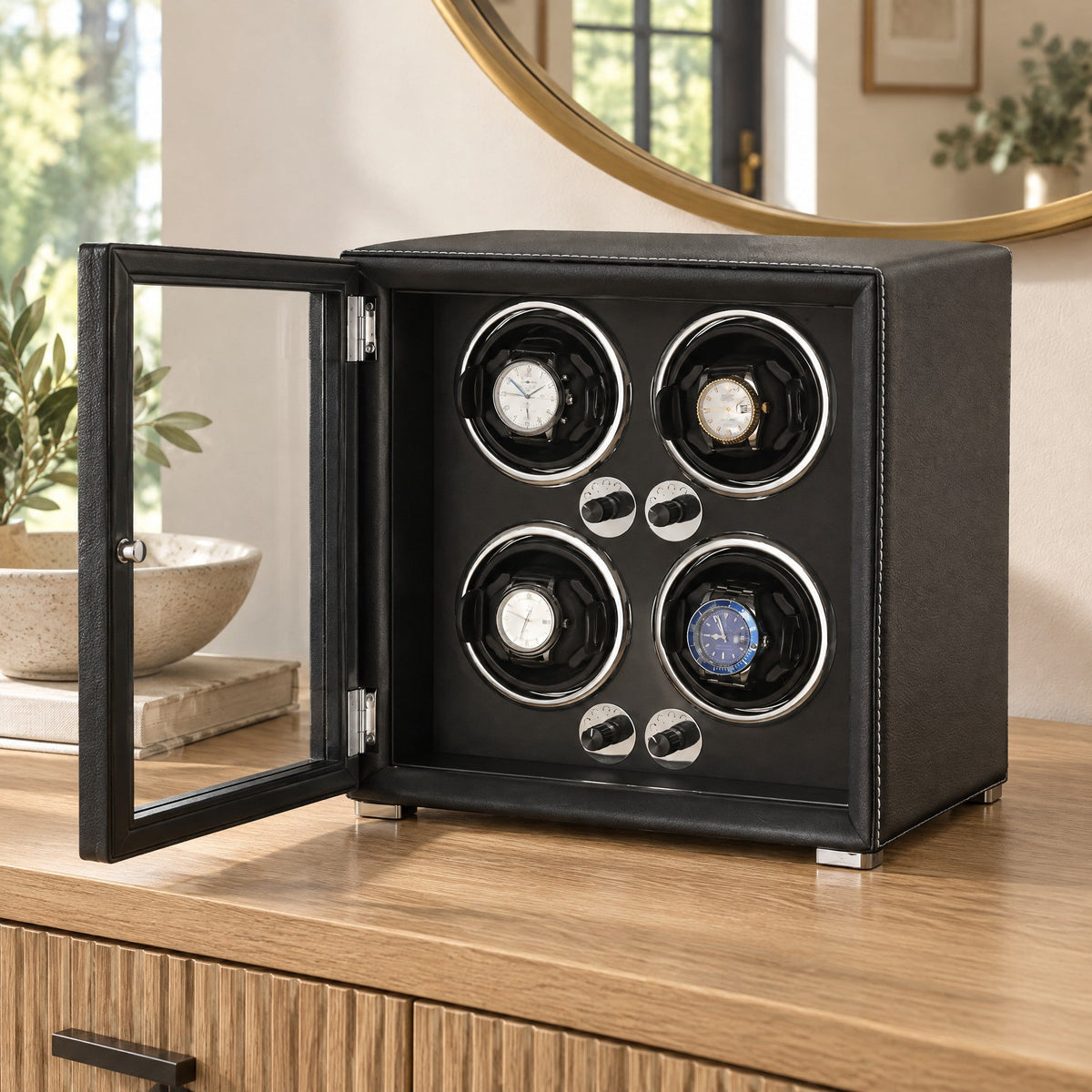 Remontoir 4 montres Balancier noir, porte vitrée ouverte, sur une console d'entrée